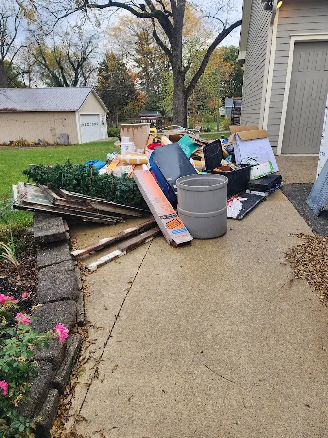 Dumpster being loaded with debris for Estate Cleanout Dumpster Rental in Rapid City